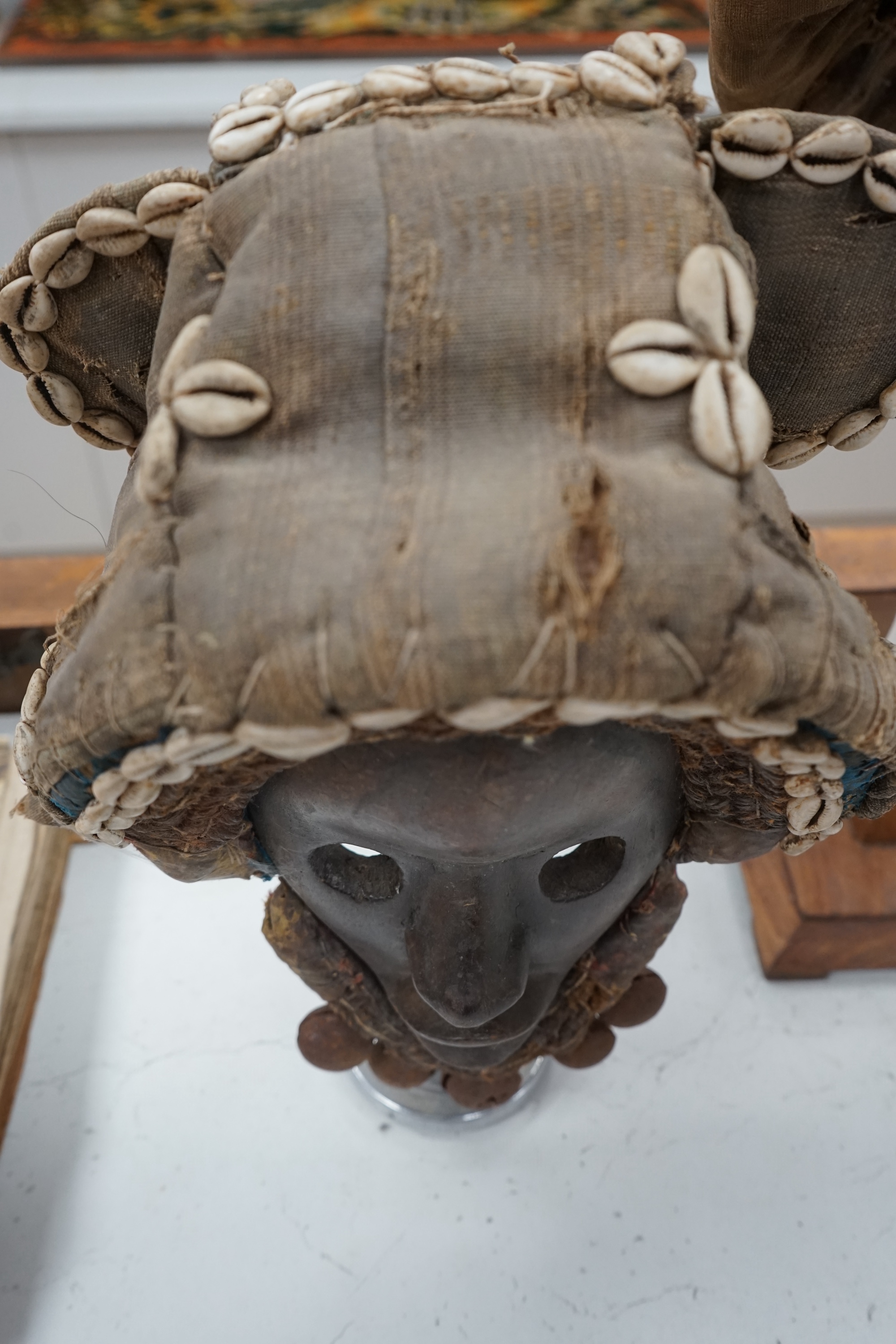 An African Ivory Coast/Liberian Dan mask together with another from the Democratic Republic Congo, both on stands, tallest 58cm including stand. Condition - some damage to the fabric of hats